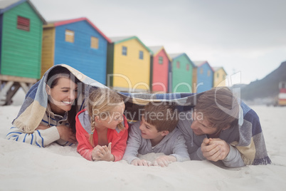 Happy family lying on sand