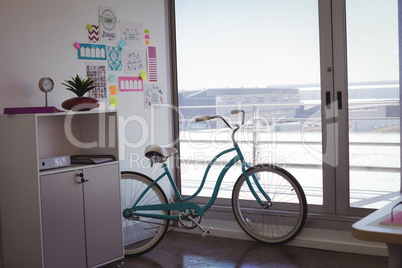 Bicycle by window in office