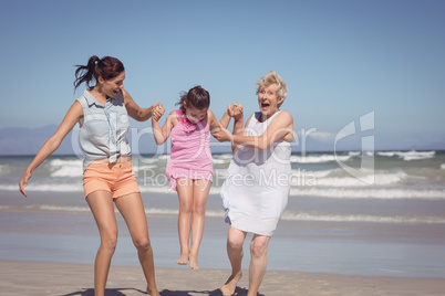 Cheerful multi-generation family playing at beach