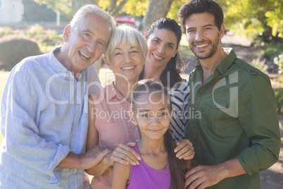 Happy family standing together in the park