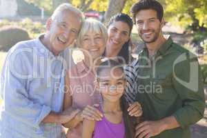 Happy family standing together in the park