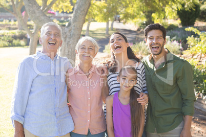 Happy family standing together in the park