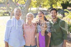 Happy family standing together in the park