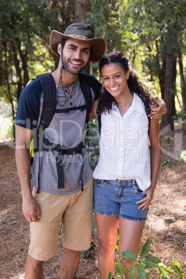 Portrait of hiker couple standing in forest