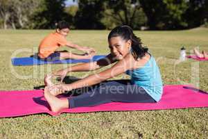 Portrait of girl touching toes during yoga glass