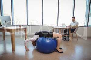 Executive exercising on fitness ball