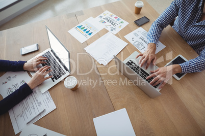 Executives using laptop at desk