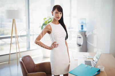 Portrait of confident executive standing at desk