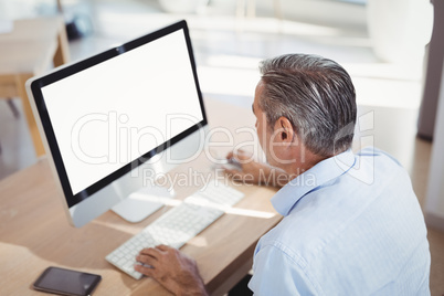 Attentive executive working on personal computer at desk