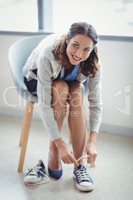 Portrait of smiling woman wearing canvas shoes