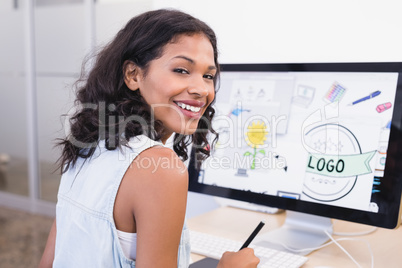 Smiling businesswoman using desktop computer