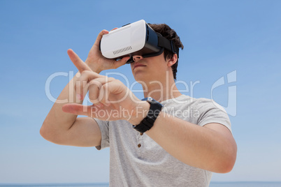 Man using vr headset against the blue sky