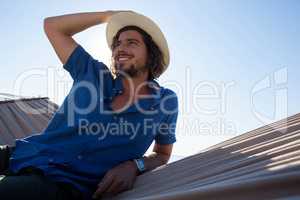 Thoughtful man relaxing on hammock at beach