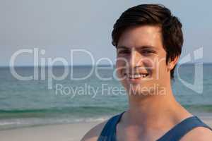 Smiling man standing at beach on a sunny day