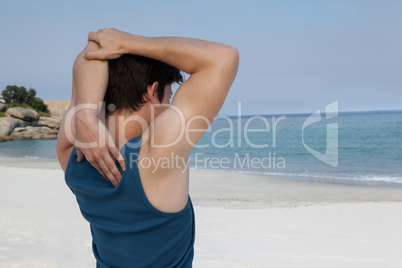 Man stretching his hand on beach
