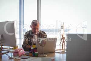 Focused businessman working on laptop at office