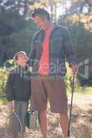 Father and son looking at each other with fishing equipment