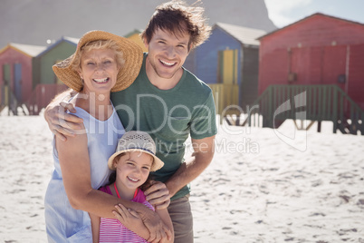 Portrait of multi-generation family embracing at beach