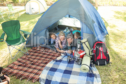 Family looking at camera in the tent