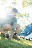 Man setting up the tent at campsite