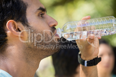 Man drinking water in park