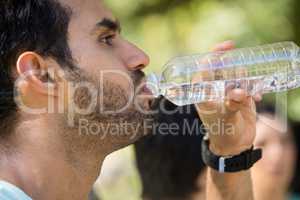 Man drinking water in park