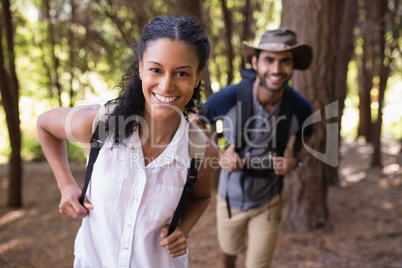 Portrait of happy couple hiking in forest