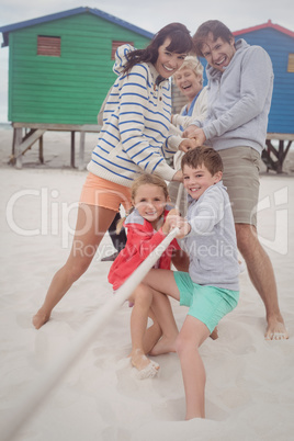 Happy multi-generation family playing tug of war