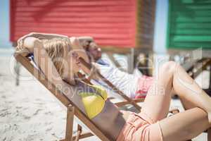 Young woman relaxaing on lounge chair at beach