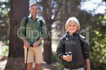 Portrait of son and father hiking on sunny day