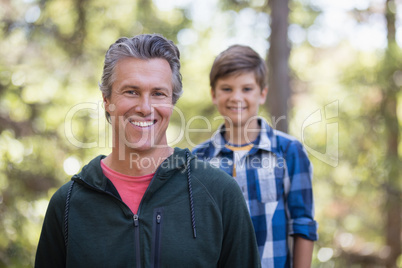 Happy father and son hiking in forest