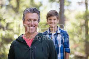 Happy father and son hiking in forest