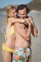 Happy couple embracing at beach