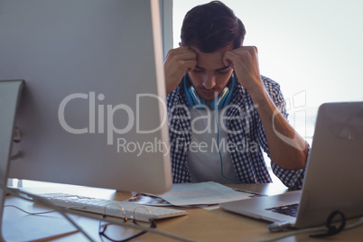 Confused graphic designer sitting in office