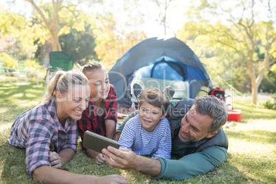 Family taking a selfie outside the tent