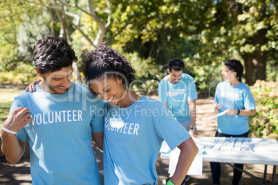 Smiling volunteers talking to each other