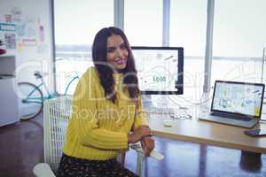 Confident businesswoman sitting at office desk