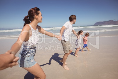 Family holding hands at beach