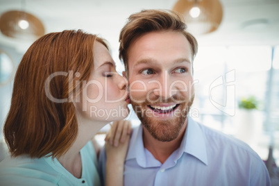 Affectionate woman kissing man