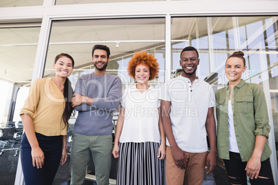 Portrait of smiling business colleagues standing side by side