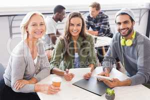 Portrait of smiling business people sitting at table