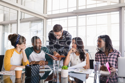 Business colleagues discussing at creative office