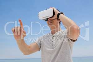 Man using vr headset against the blue sky