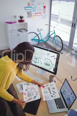Female graphic designer working at office desk