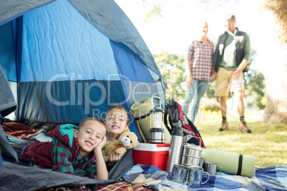 Siblings lying in the tent