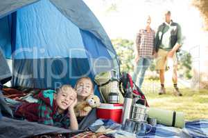 Siblings lying in the tent