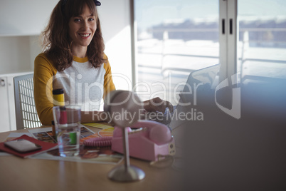 Portrait of smiling businesswoman working at office