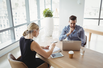 Attentive executives working at desk