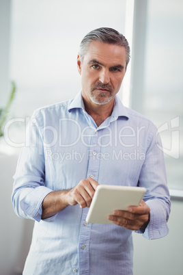 Portrait of executive using digital tablet