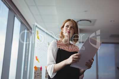 Thoughtful executive holding documents